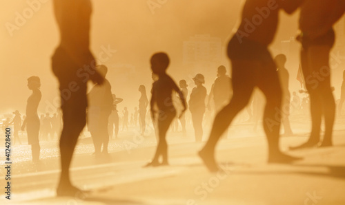 A group of beach goers enjoy the last bit of hazy summer sun in Rio De Janeiro, Brazil