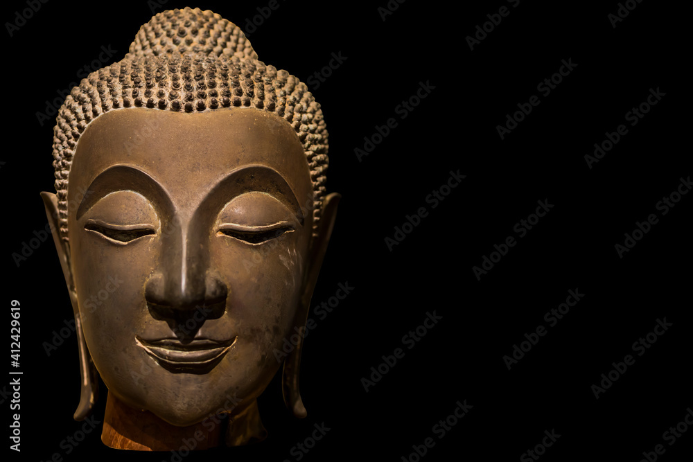Ancient Buddha Face isolated on black background