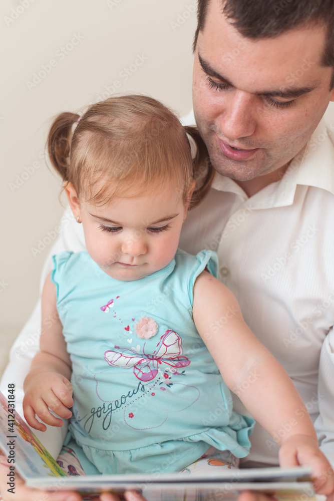 Father reading to his daughter