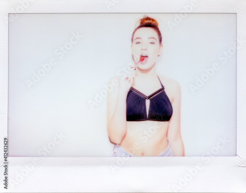Young woman eating lollipop