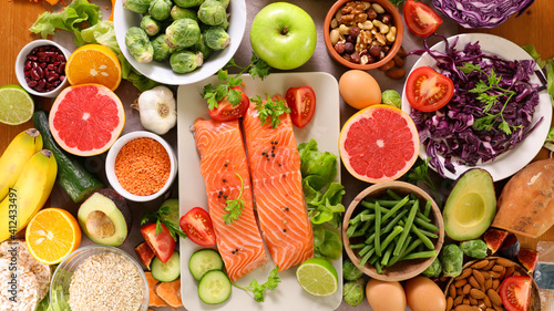 health food selection- salmon, avocado, fruit, nuts
