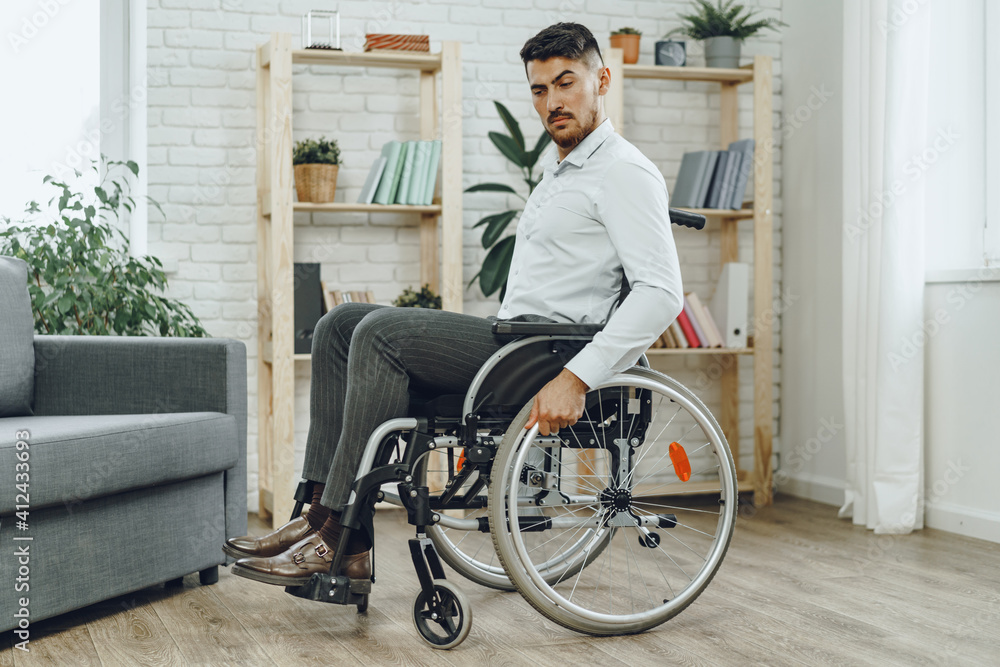 Portrait of disabled man in formal wear sitting in a wheelchair Portrait of disabled man in formal wear sitting in a wheelchair