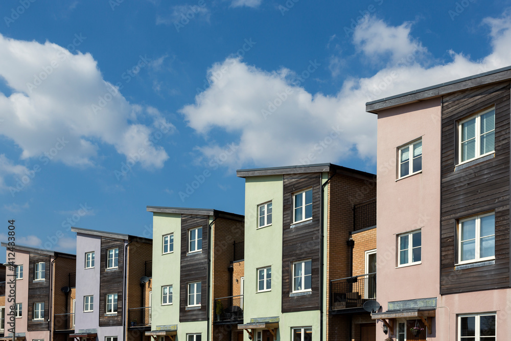 A group of new houses in a line soft pastel colour A group of new houses in a line soft pastel colour