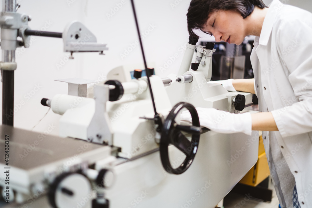 Female Scientist Looking Through the Microscope Female Scientist Looking Through the Microscope