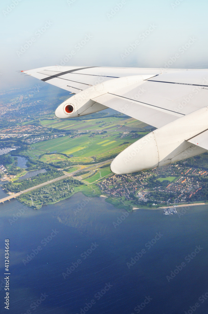 view from an airplane flying over the sea view from an airplane flying over the sea