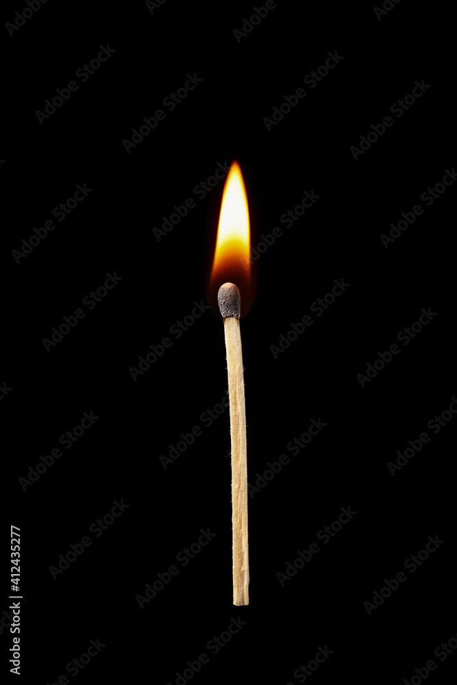Burning match on dark background Burning match on dark background