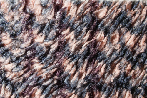 Close-up fabric texture. Fabric background. Fancy curls of colored fabric fibers. Increased tissue structure.
