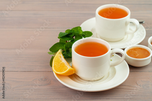 Cup of tea served with lemon and mint