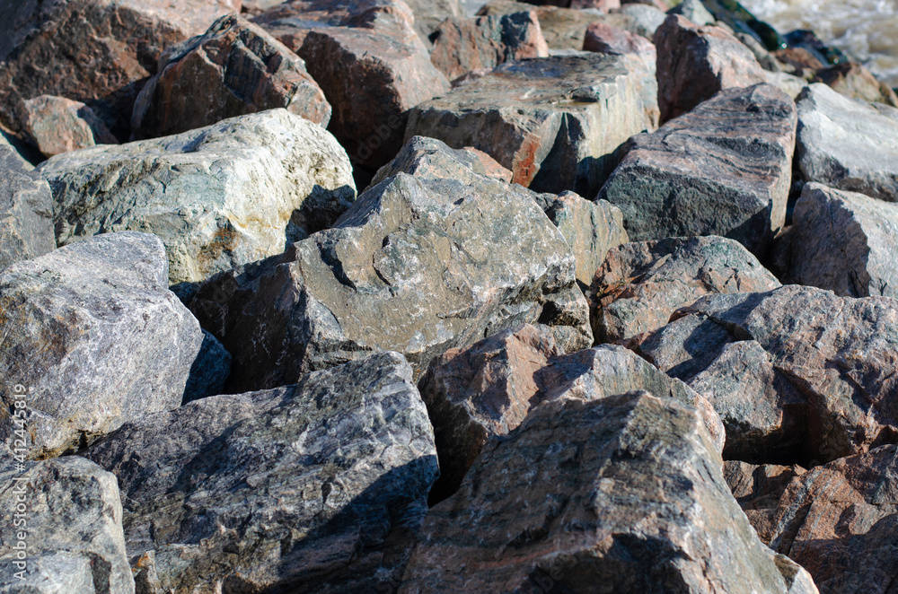 Rock. Granite. Large stones. The structure of the stone. Breakwater.