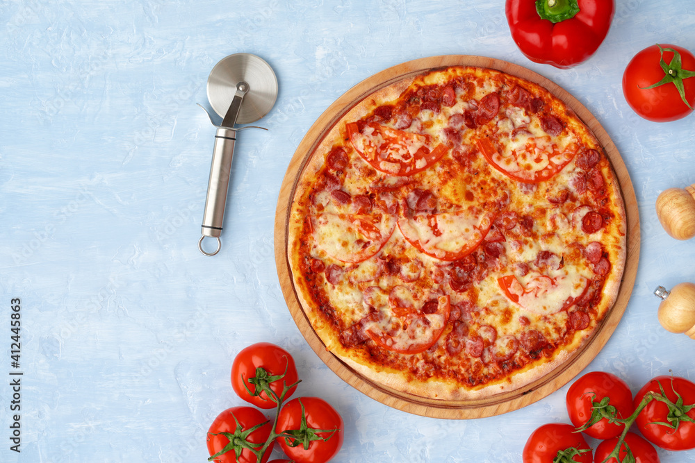 Delicious pizza with sausages on gray background