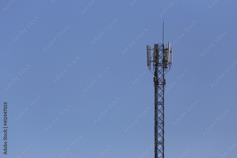 Signal tower on a blue sky background. Signal tower on a blue sky background.