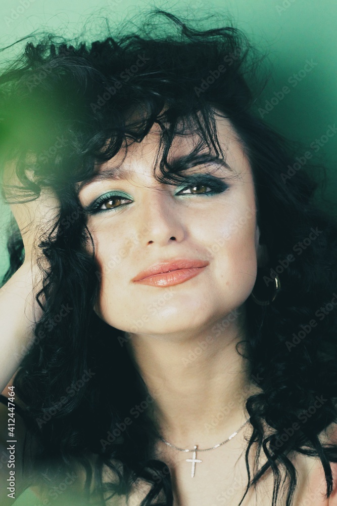 Beautiful young brunette model with bright make-up and curly hairstyle Beautiful young brunette model with bright make-up and curly hairstyle