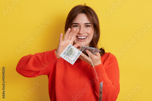 Photos Woman throws up cash, lottery winner with very happy expression, looking directly at camera and smiling, lady with banknotes indoor, dark haired girl with her currency, has reward