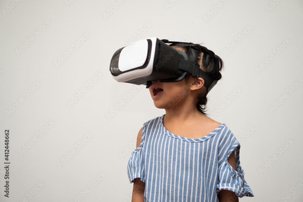 Little Asian girl child with virtual reality headset is exciting for new experiencing. Concept of 3D gadget technology and virtual world gadgets game and online education in the future Little Asian girl child with virtual reality headset is exciting for new experiencing. Concept of 3D gadget technology and virtual world gadgets game and online education in the future