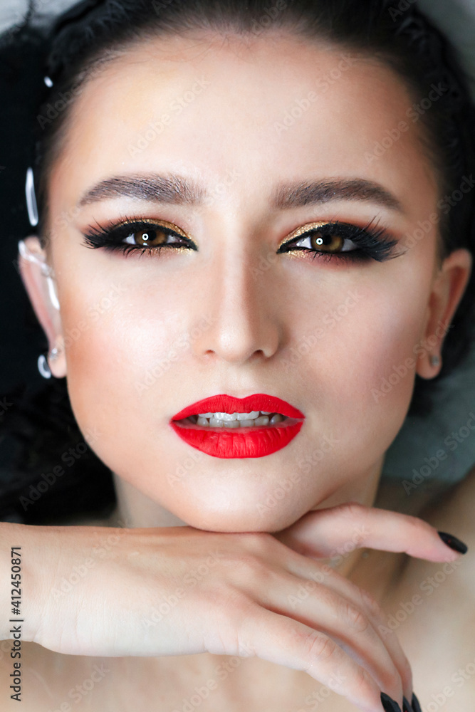 Beautiful young brunette model with bright make-up in bath, water