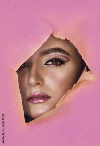 Obraz na płótnie Beautiful young model with bright make-up in pink tropical background w salonie