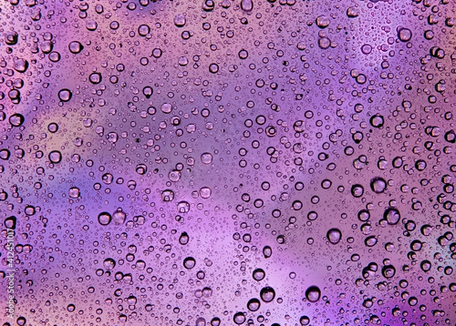 Abstract background of bubbles, water droplets on a purple background graphic quality
