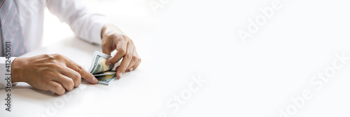 Bilde på lerret A businessman counting his dollar bills on a white table, counting the money to invest in the funds and stocks he usually buys every month
