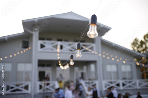 Сozy house with a terrace and light bulbs