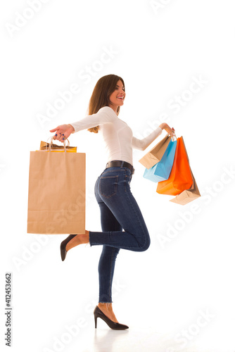 Beautiful girl in jeans after successful shopping.