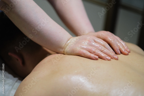Close-up of man enjoying in relaxing back massage . Man relaxing on massage table receiving massage