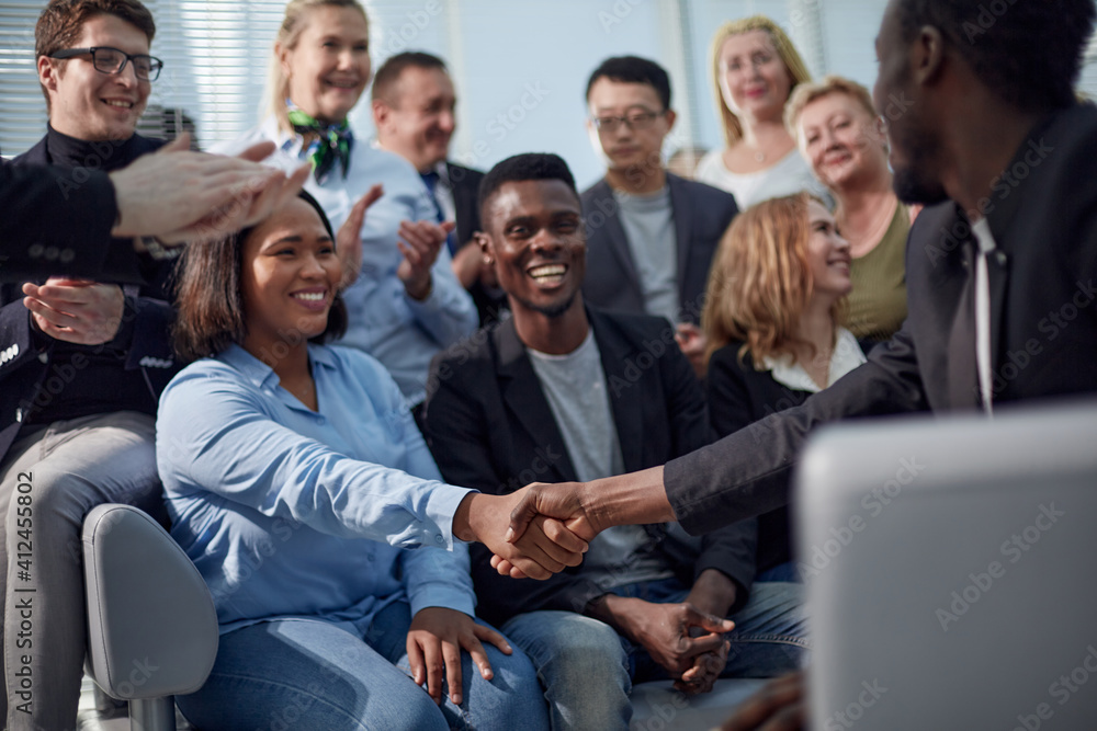 Handshake between a businesswoman and a co-worker Handshake between a businesswoman and a co-worker