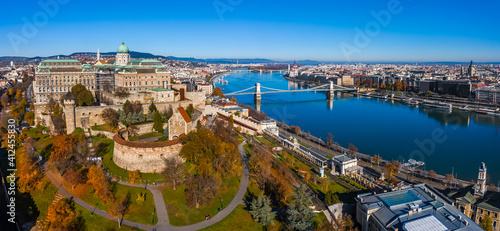 Budapest, Hungary - Aerial panoramic view of Buda Castle Royal Palace with Szechenyi Chain Bridge, Parliament building, River Danube and St.Stephen's Basilica on a sunny autumn day with clear blue sky © zgphotography