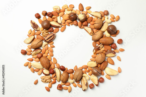 Different tasty nuts on white background, space for text photo