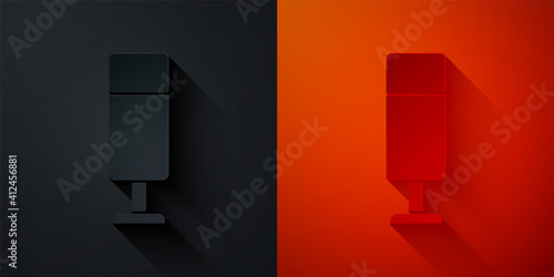 Paper cut Punching bag icon isolated on black and red background. Paper art style. Vector.