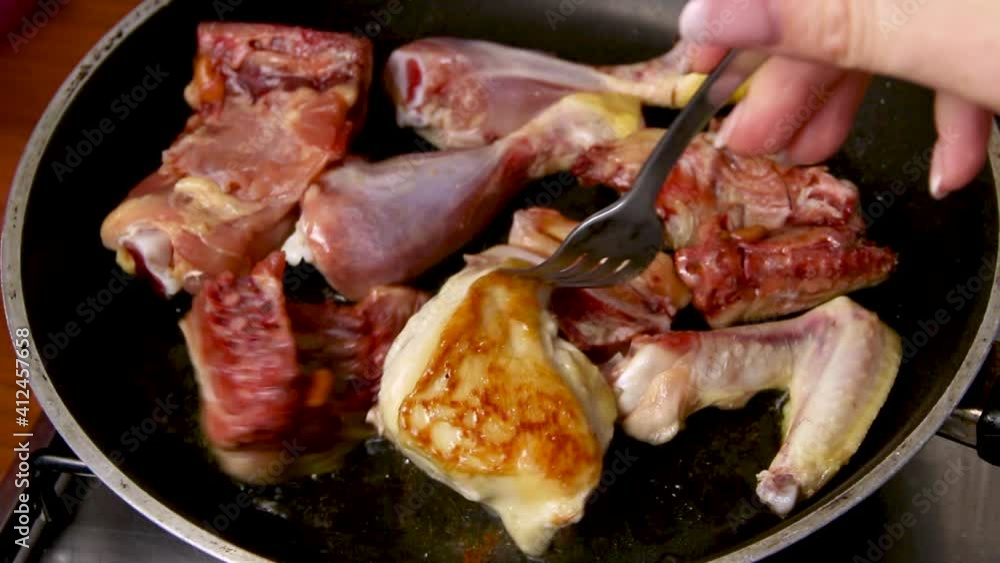 Fresh chicken pieces in the frying pan close up Fresh chicken pieces in the frying pan close up