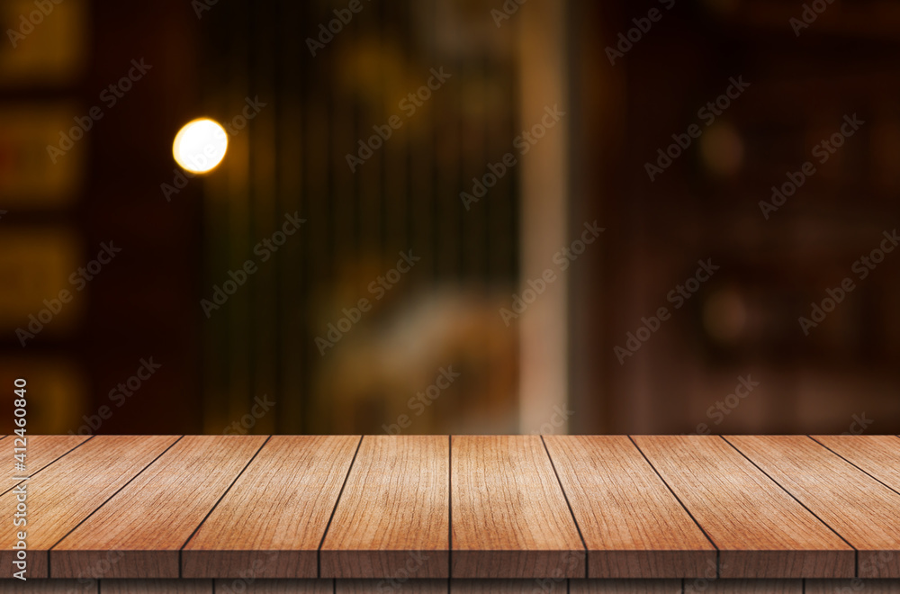 Empty wooden table top with lights bokeh on blur restaurant background.
Empty wooden table top with lights bokeh on blur restaurant background.