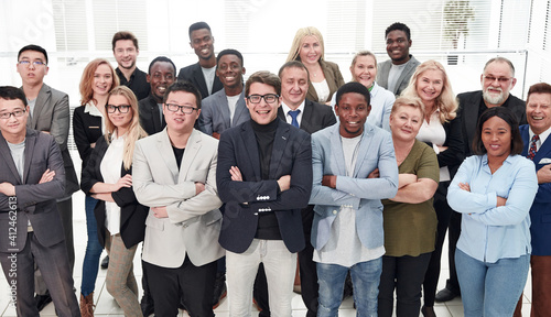 Business people with arms crossed standing near the window in co