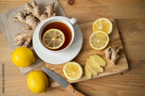 Ingredient for warming tea. Whole and sliced ginger roots, lemon on white background top view