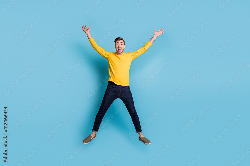 Full size portrait of astonished guy jumping high make star figure isolated on blue color background