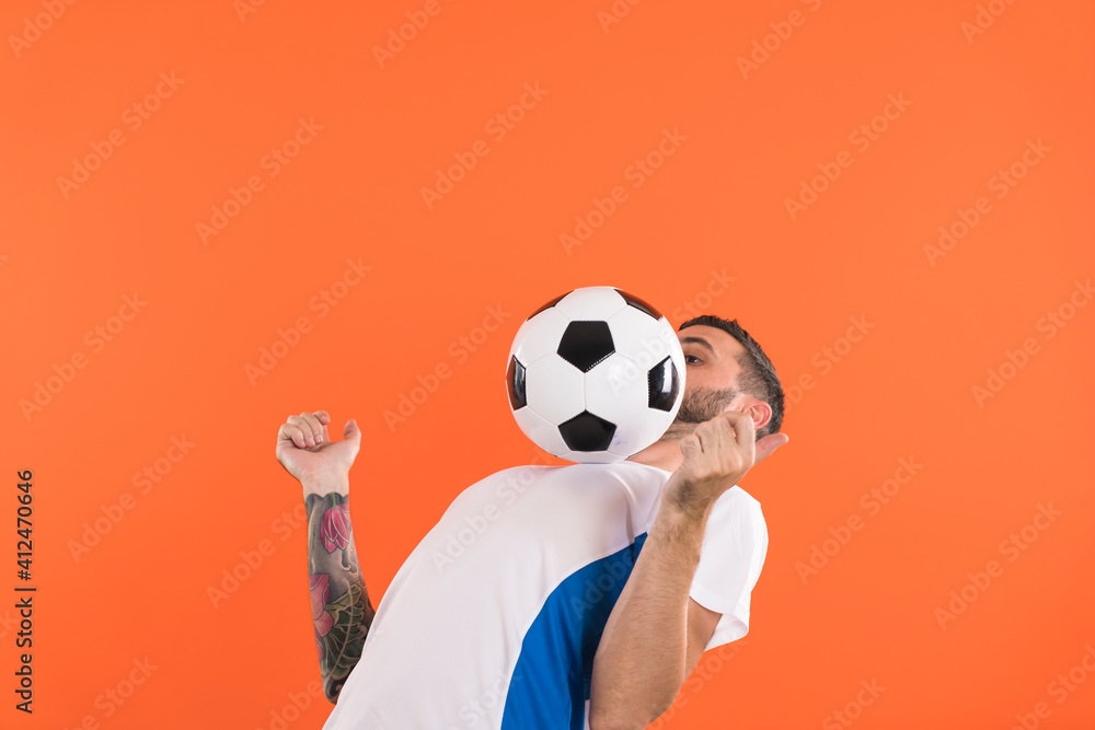 Football player balance the ball at chest Football player balance the ball at chest