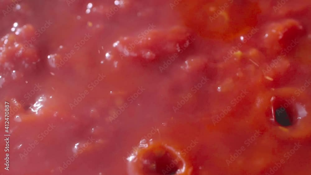 Closeup of a boiling traditional bolognese sauce. Tasty pasta sauce with minced meat, tomatoes, carrot and onion. Closeup of a boiling traditional bolognese sauce. Tasty pasta sauce with minced meat, tomatoes, carrot and onion.