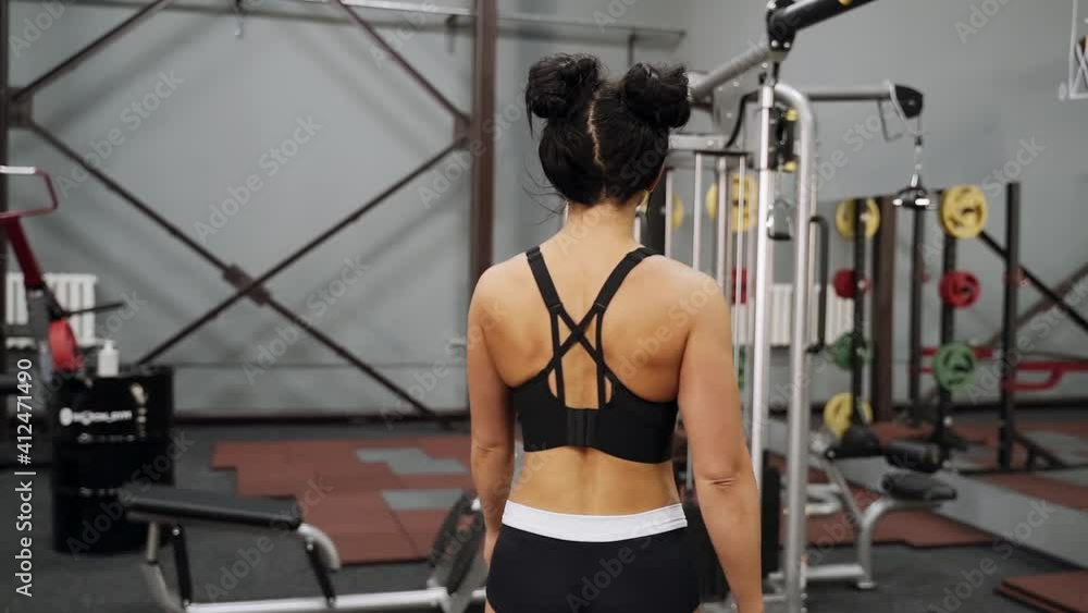 Beautiful woman posing in the gym. She shows her amazing body in different positions. Athlete portrait Beautiful woman posing in the gym. She shows her amazing body in different positions. Athlete portrait