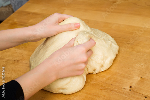 Woman hands knead dough on the kitchen table. Homemade dough. homemade baking
