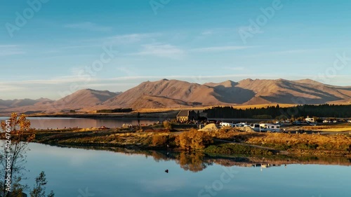Lake Tekapo in Mackenzie Basin in the South Island of New Zealand, people being busy from morning to night, time lapse of beautiful natural landscape photo