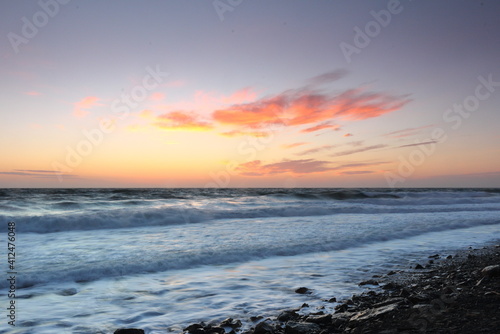 bright colors of the sunset over the undulating sea