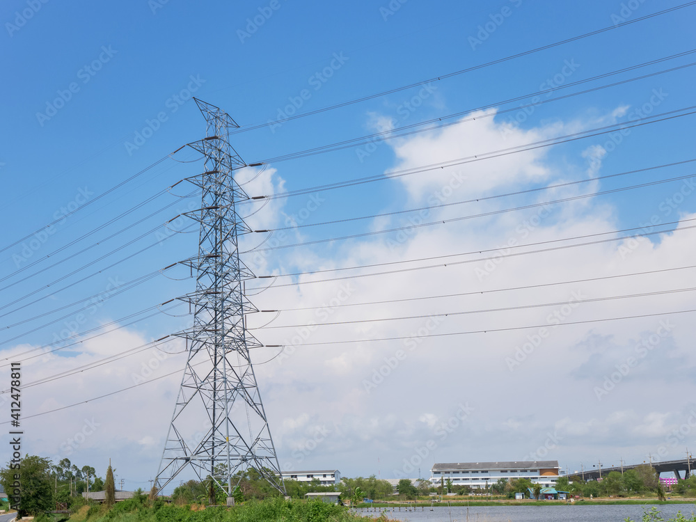 high voltage transmission tower with power line over blue sky and white cloud background the electricity infrastructure from power plant to industrial and household
