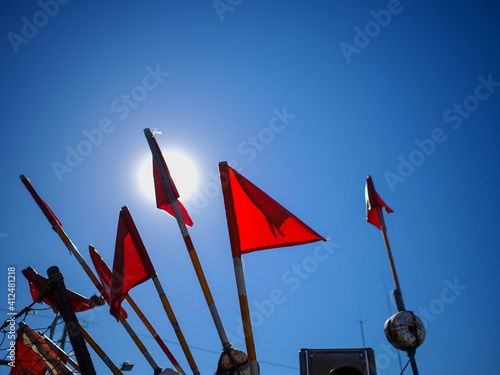 red flags against blue sky