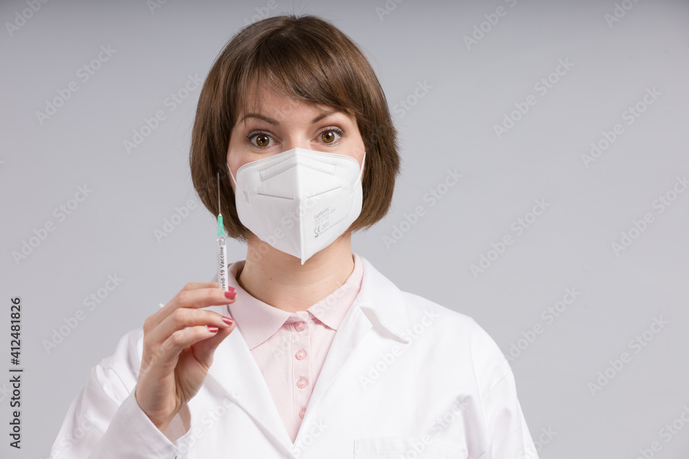 female doctor or nurse with a syringe pulled up with a vaccine female doctor or nurse with a syringe pulled up with a vaccine