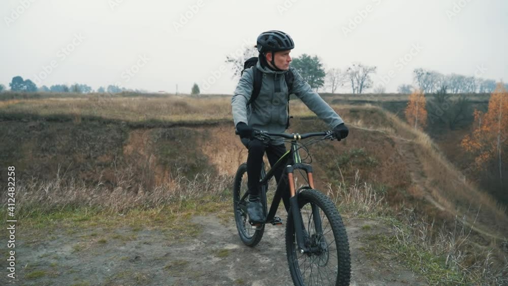 Man cyclist ready to ride a mountain bike in down the hill Man cyclist ready to ride a mountain bike in down the hill