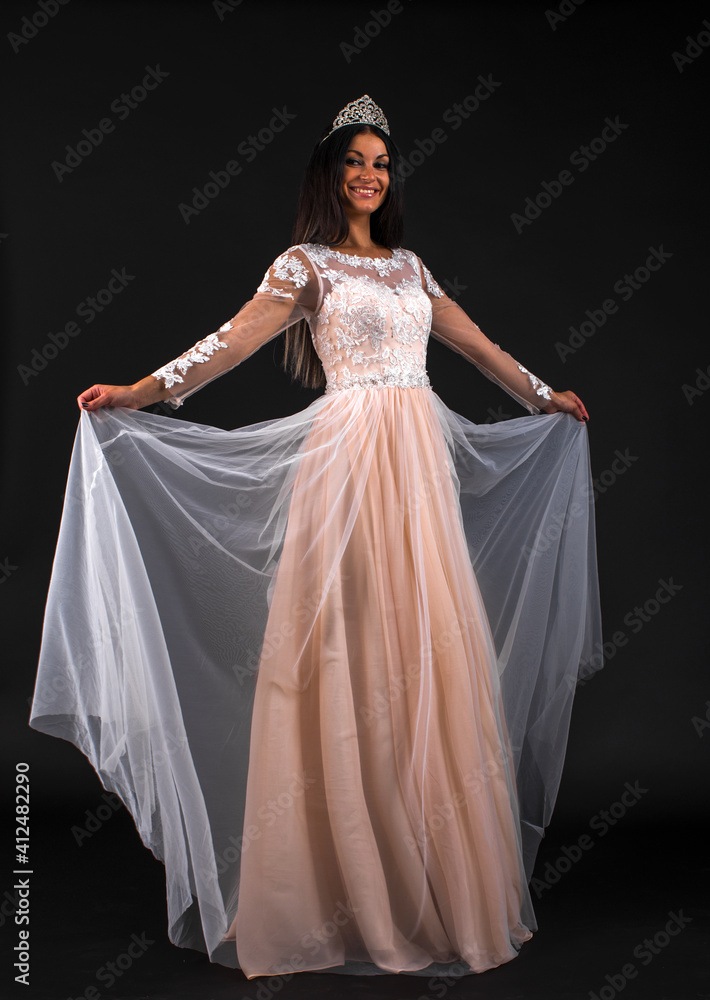 Portrait of young beautiful woman in long dress