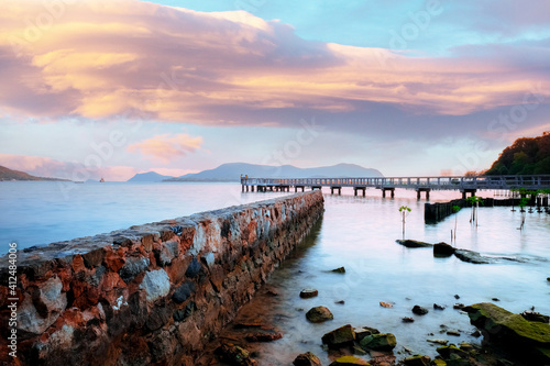Stone bridge in the middle of the sea Evening Time Beautiful Sunset Sea scape © Wisan