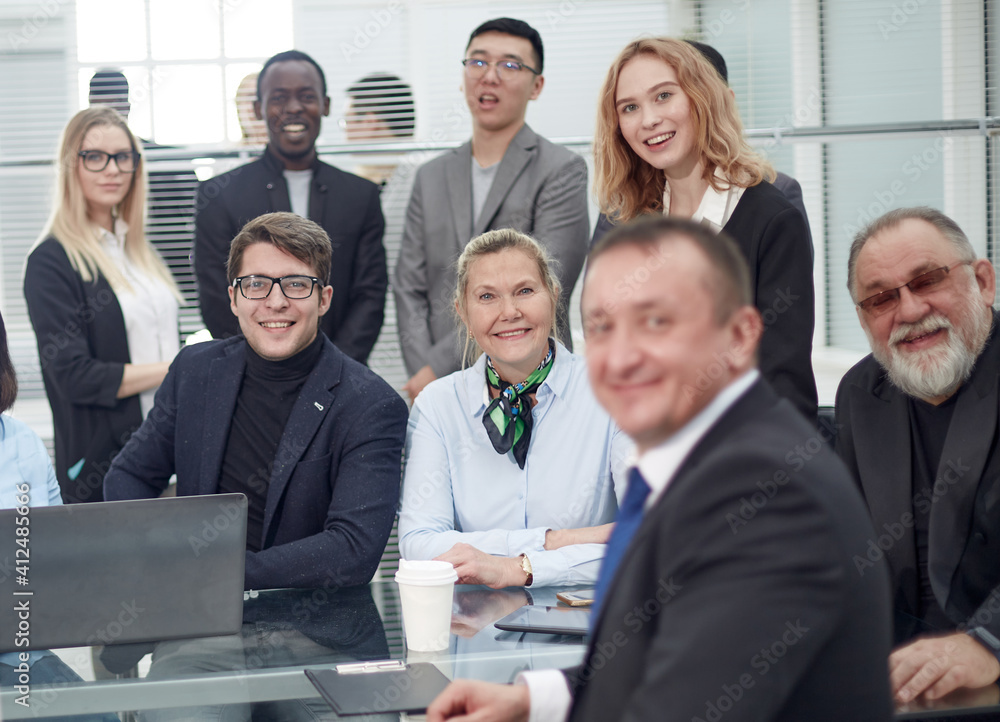Portrait of successful group of business people at modern office. Happy businessmen and satisfied businesswomen standing as a team in office Portrait of successful group of business people at modern office. Happy businessmen and satisfied businesswomen standing as a team in office