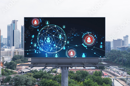 Glowing Social media icons on road billboard over panoramic city view of Kuala Lumpur, Malaysia, Asia. The concept of networking and establishing new connections between people and businesses in KL.