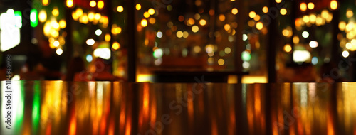 reflection of party light on wood table in pub or bar in Christmas night banner background