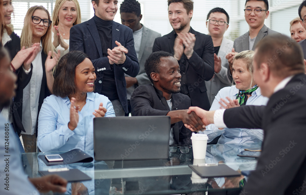 business people shaking hands over an office Desk. business people shaking hands over an office Desk.
